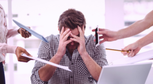 A tired entrepreneur surrounded by piles of documents and process charts, reflecting the challenges of managing complex workflows in a busy office environment.